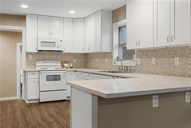 kitchen featuring white cabinets, dark hardwood / wood-style floors, white appliances, and sink