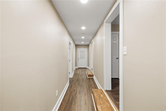 corridor with wood-type flooring