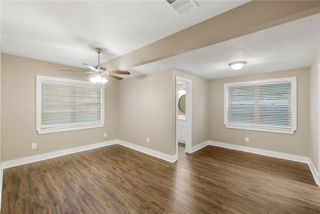 spare room with ceiling fan and dark wood-type flooring