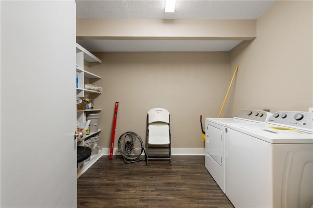 clothes washing area with a textured ceiling, dark hardwood / wood-style flooring, and separate washer and dryer