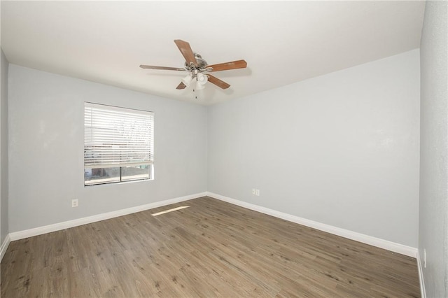 spare room featuring hardwood / wood-style flooring and ceiling fan