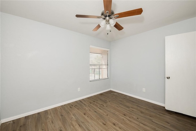 empty room featuring ceiling fan and dark hardwood / wood-style floors