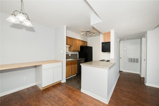 kitchen featuring sink, black appliances, dark hardwood / wood-style flooring, and built in desk