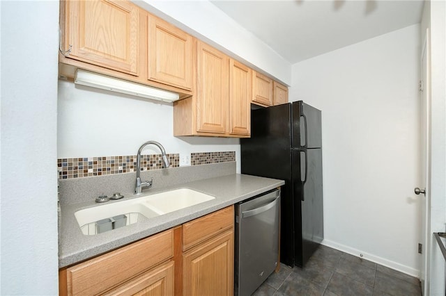 kitchen featuring light brown cabinets, sink, stainless steel dishwasher, and decorative backsplash