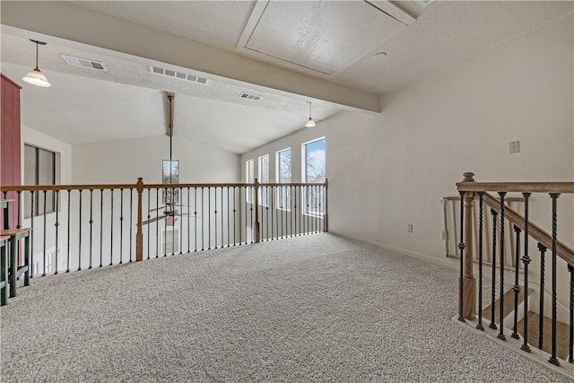 empty room with vaulted ceiling with beams, carpet floors, and a textured ceiling