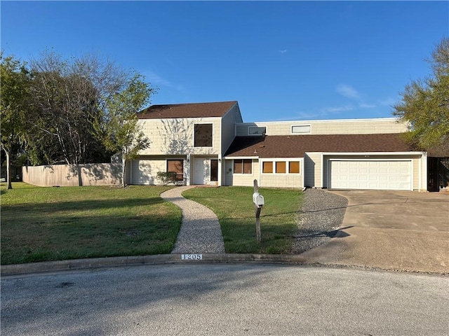 view of front facade with a garage, concrete driveway, a front lawn, and fence