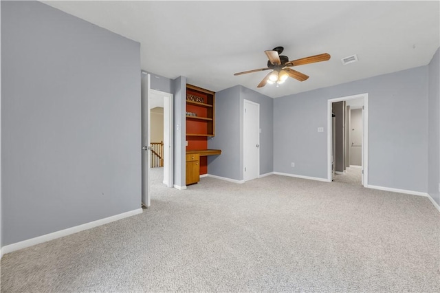 unfurnished bedroom with ceiling fan and light carpet