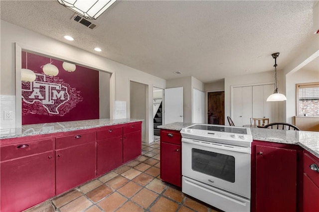 kitchen with electric range, tile patterned flooring, a textured ceiling, and hanging light fixtures