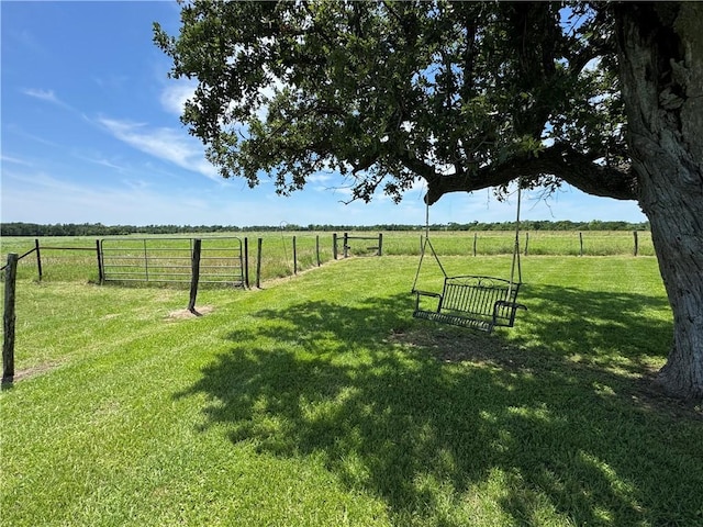 view of yard featuring a rural view and fence