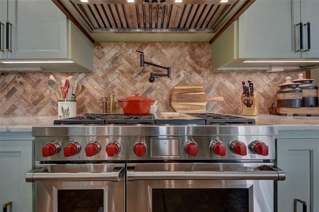 3151 Running River Ln, Washington, TX 77880 - kitchen featuring range with two ovens, custom exhaust hood, and tasteful backsplash