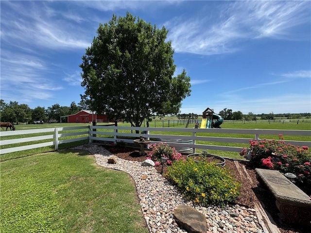 view of yard featuring a rural view and fence