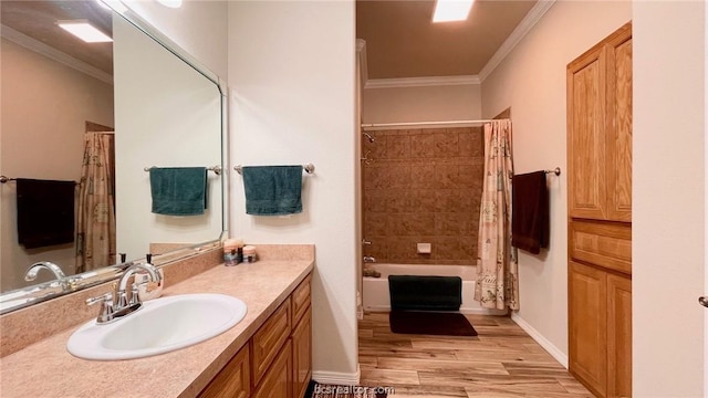 bathroom with crown molding, shower / bath combo with shower curtain, vanity, and wood-type flooring