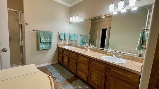 bathroom with tile patterned flooring, vanity, ornamental molding, and a shower with door