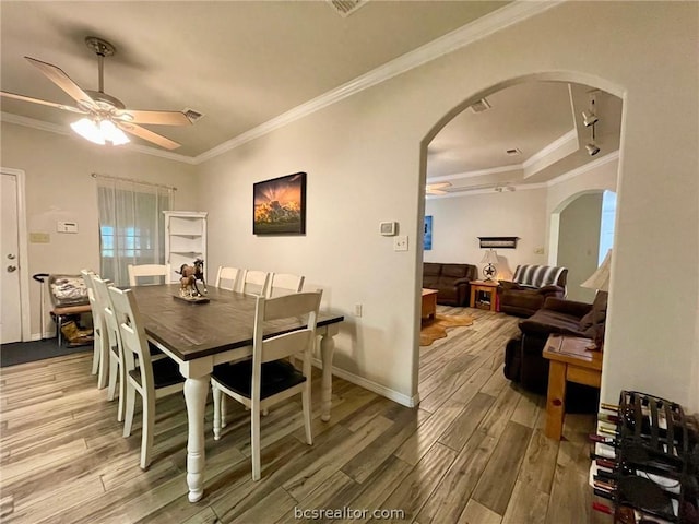 dining area with hardwood / wood-style floors, ceiling fan, and crown molding