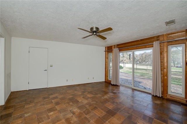 spare room featuring ceiling fan and a textured ceiling