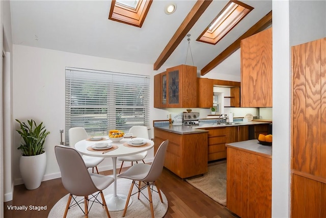 kitchen featuring sink, hardwood / wood-style flooring, and lofted ceiling with skylight