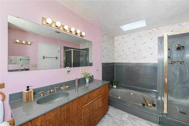 bathroom featuring independent shower and bath, vanity, a textured ceiling, and a skylight