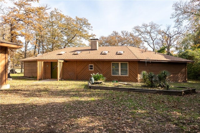 rear view of house with a yard