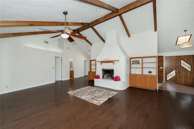 living room with dark hardwood / wood-style floors, ceiling fan, a fireplace, and beamed ceiling