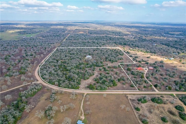 birds eye view of property with a rural view