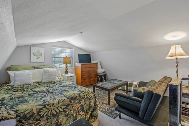 bedroom featuring a textured ceiling, carpet flooring, and lofted ceiling