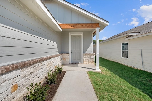 doorway to property featuring a yard