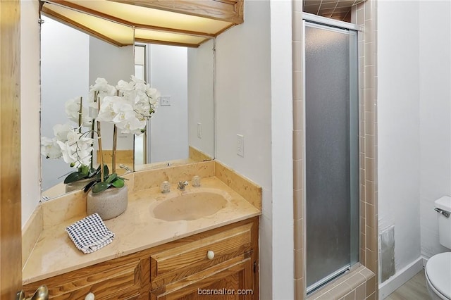 bathroom with vanity, hardwood / wood-style flooring, toilet, and a shower with shower door