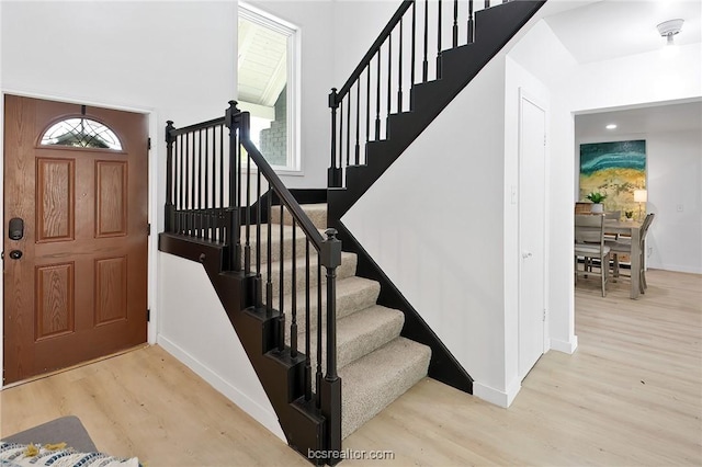 staircase with hardwood / wood-style floors