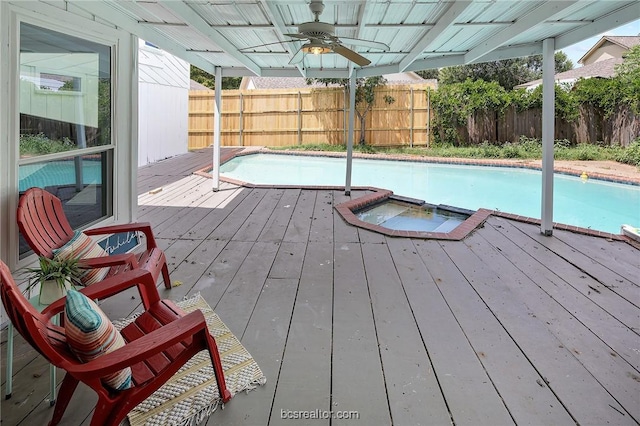 view of pool featuring ceiling fan and a wooden deck