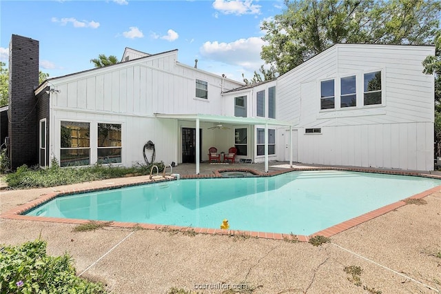 rear view of property with ceiling fan and a patio