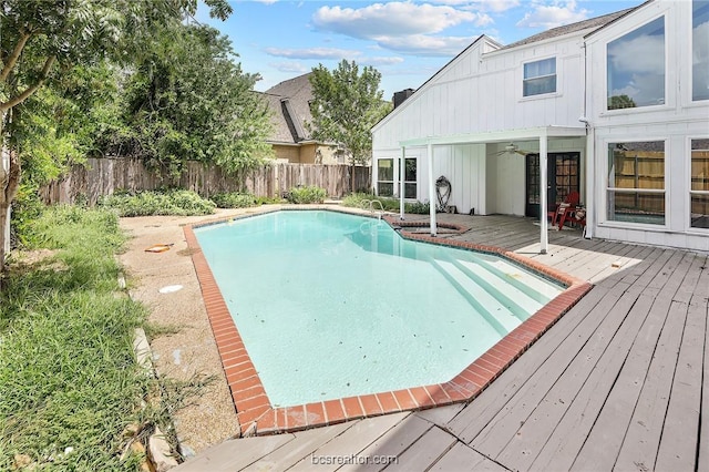 view of swimming pool with ceiling fan and a wooden deck