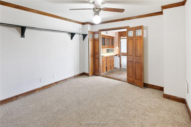 unfurnished room featuring light carpet, ceiling fan, and crown molding