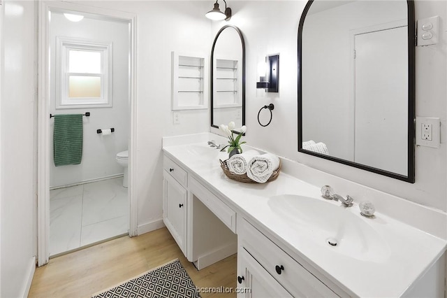 bathroom featuring hardwood / wood-style floors, vanity, and toilet