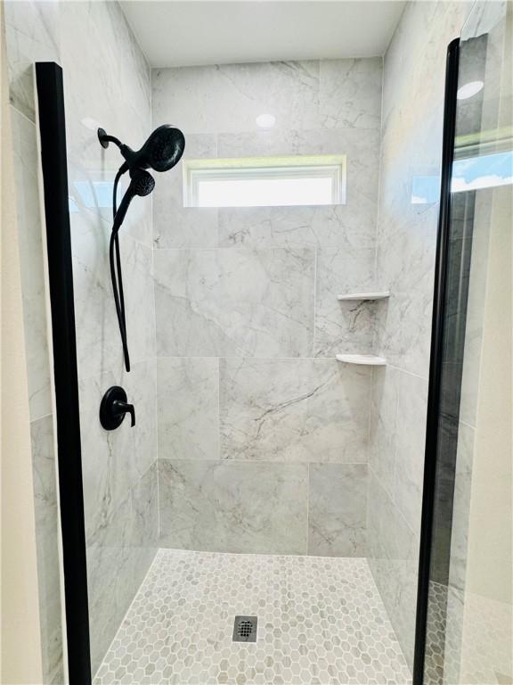 bathroom with tiled shower