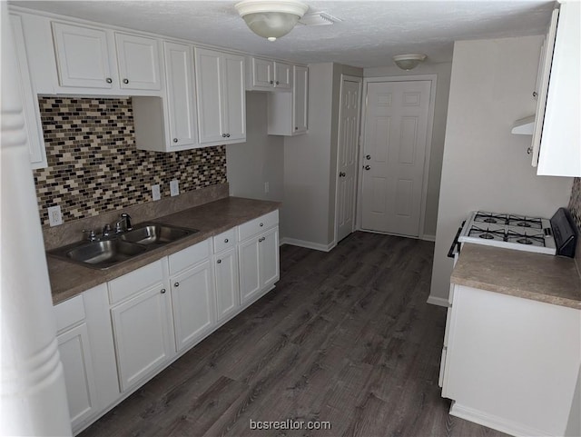 kitchen with dark hardwood / wood-style flooring, white cabinetry, and sink