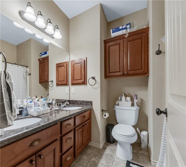 bathroom with a shower with curtain, vanity, tile patterned floors, and toilet