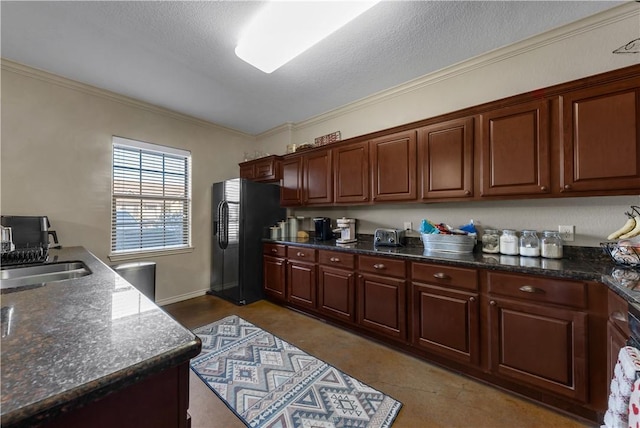 kitchen with sink, crown molding, a textured ceiling, black fridge with ice dispenser, and dark stone counters