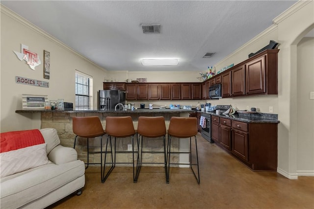 kitchen featuring a breakfast bar, dark brown cabinets, ornamental molding, black appliances, and a textured ceiling