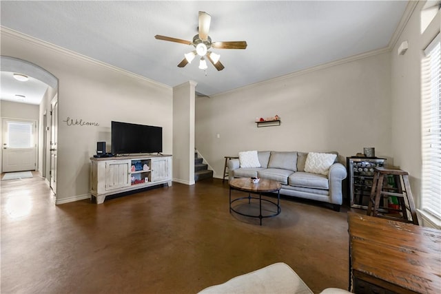 living room featuring ceiling fan, a healthy amount of sunlight, beverage cooler, and ornamental molding