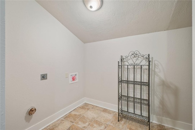 clothes washing area with electric dryer hookup, washer hookup, and a textured ceiling