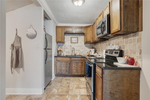 kitchen featuring decorative backsplash, stainless steel appliances, crown molding, and sink