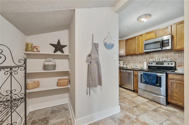 kitchen featuring tasteful backsplash, stainless steel appliances, and a textured ceiling