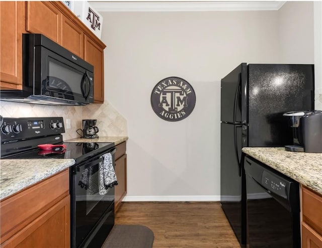 1198 Jones Butler Rd Unit 3103, College Station, TX 77840 - kitchen featuring black appliances, tasteful backsplash, ornamental molding, dark wood-style floors, and brown cabinetry