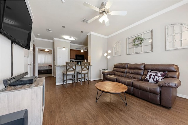 1198 Jones Butler Rd Unit 3103, College Station, TX 77840 - living area with dark wood finished floors, crown molding, ceiling fan, and baseboards