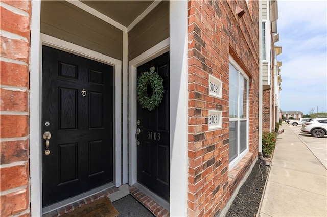 1198 Jones Butler Rd Unit 3103, College Station, TX 77840 - doorway to property featuring brick siding and a porch