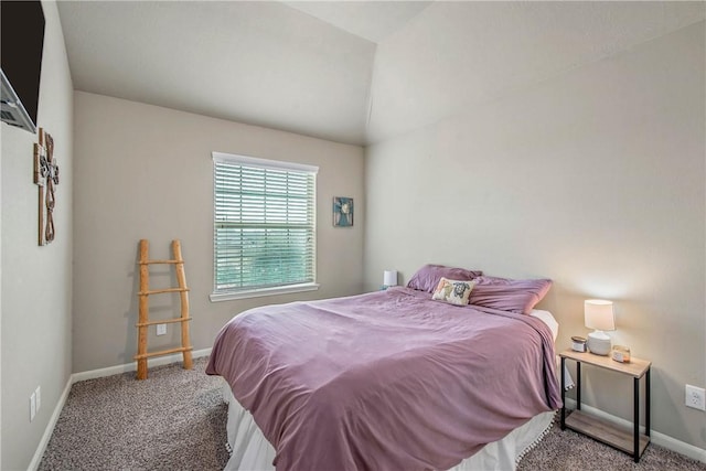 bedroom featuring lofted ceiling and carpet flooring