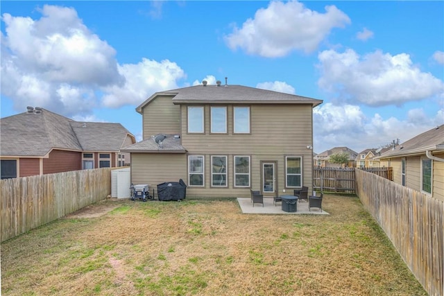 back of house with a yard and a patio