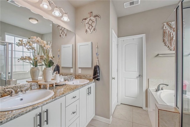 bathroom featuring tile patterned flooring, vanity, and a bath