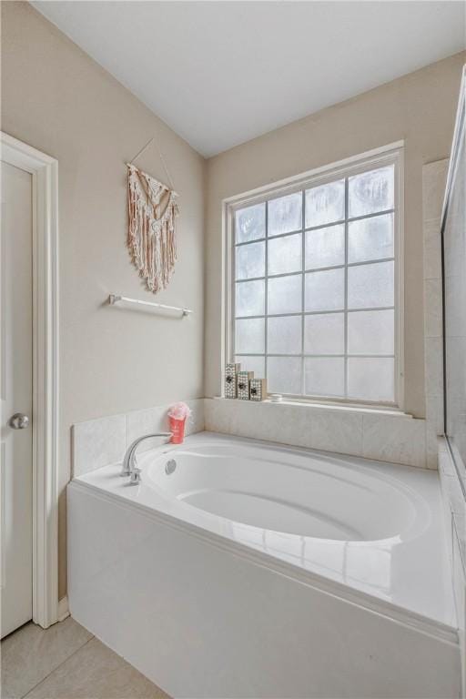 bathroom with a bathtub and tile patterned floors