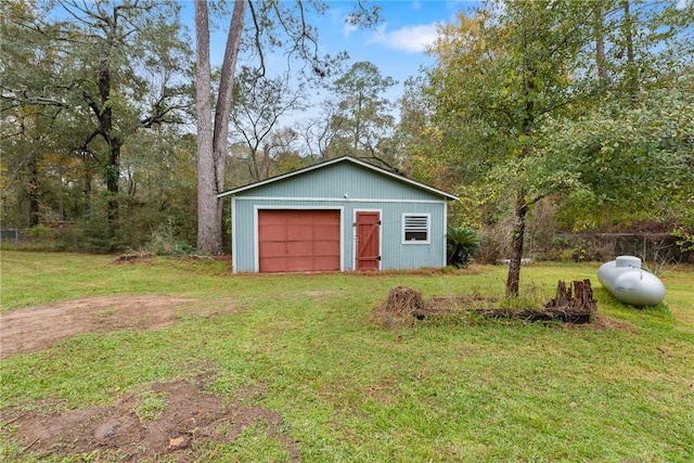 view of outbuilding with a yard and a garage